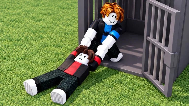 A player drags a knocked-out avatar toward an open jail cell on grass
